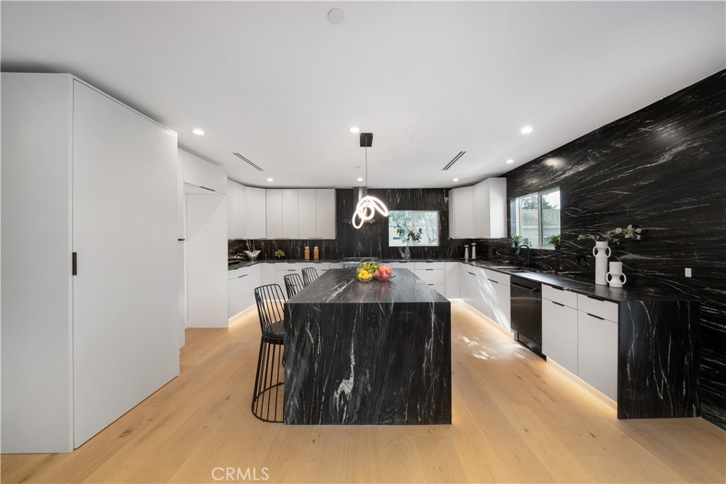 2982 Glendale Boulevard Los Angeles, CA 90039 - Photo 10 of 47 a kitchen with stainless steel appliances kitchen island granite countertop a stove a sink and a refrigerator