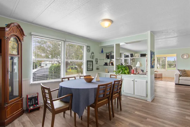 a dining room with furniture window and wooden floor