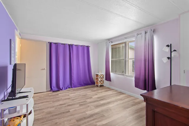 a bed sitting in a bedroom next to a window