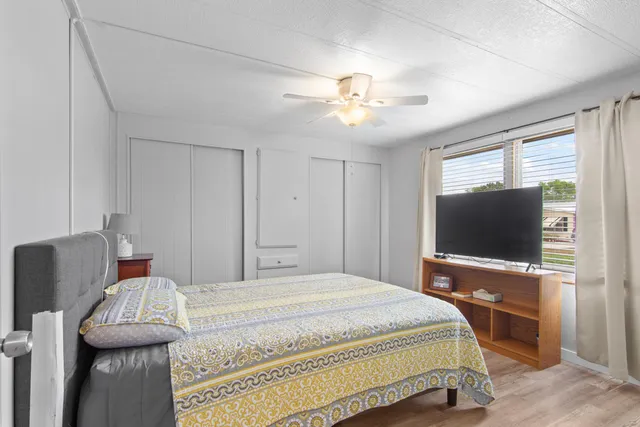 a bedroom with a bed and a flat screen tv