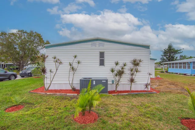 a view of a backyard with table and chairs and potted plants