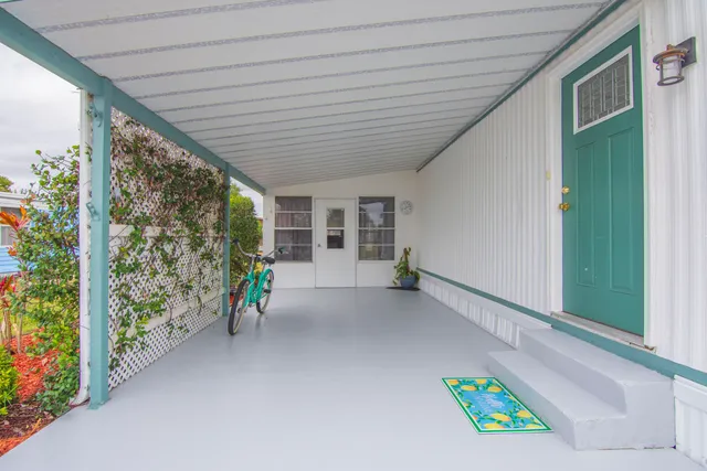 a view of a patio with table and chairs and potted plants