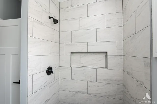 a brick house with a big yard and large trees