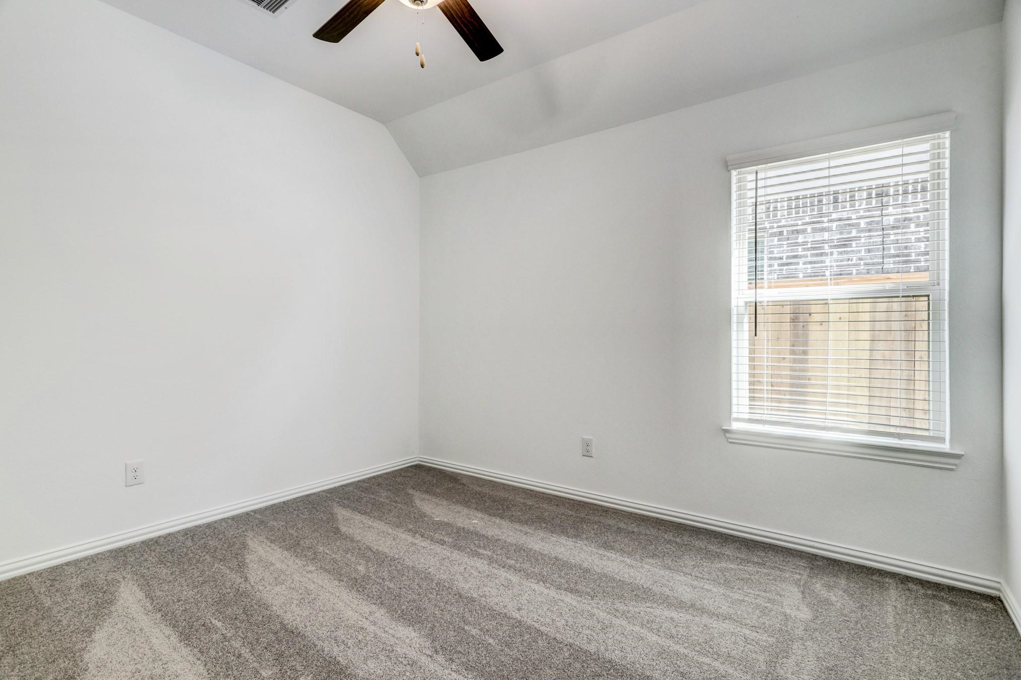 21015 Morning Nectar Lane Cypress, TX 77433 - Photo 15 of 34 an empty room with a window and a ceiling fan