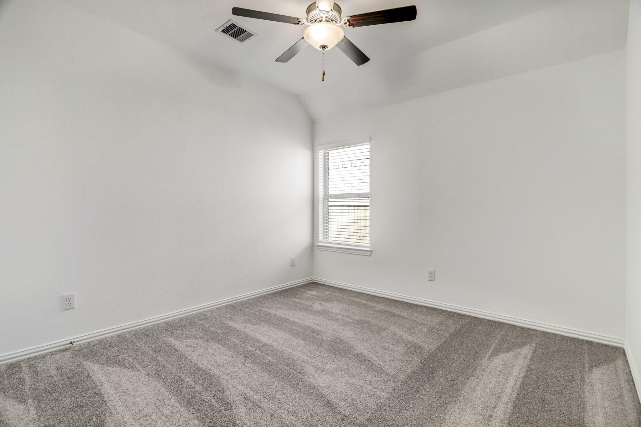 21015 Morning Nectar Lane Cypress, TX 77433 - Photo 17 of 34 wooden floor in an empty room with a window
