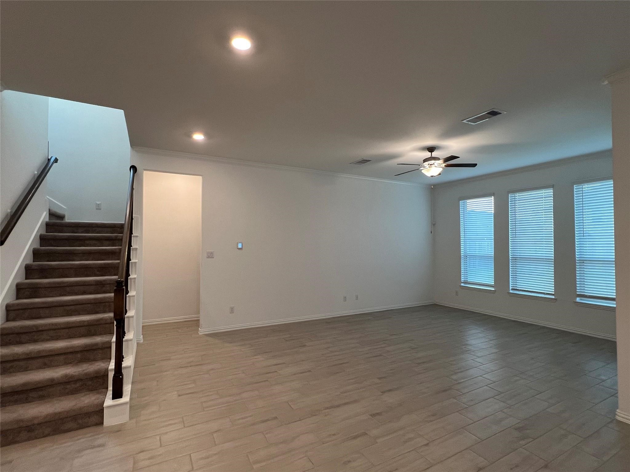 21015 Morning Nectar Lane Cypress, TX 77433 - Photo 20 of 34 an empty room with wooden floor and windows