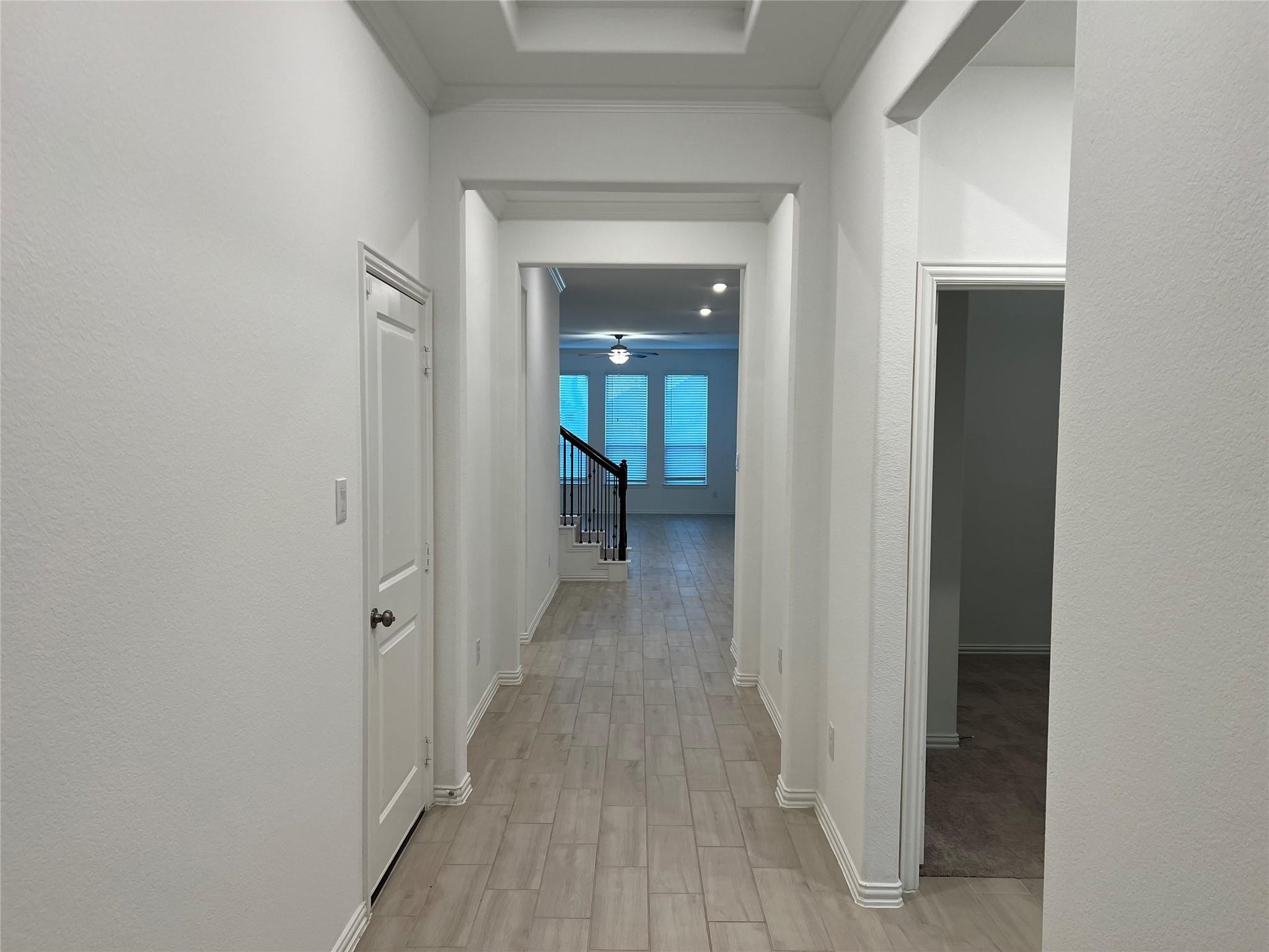 21015 Morning Nectar Lane Cypress, TX 77433 - Photo 2 of 34 a view of a hallway with wooden floor