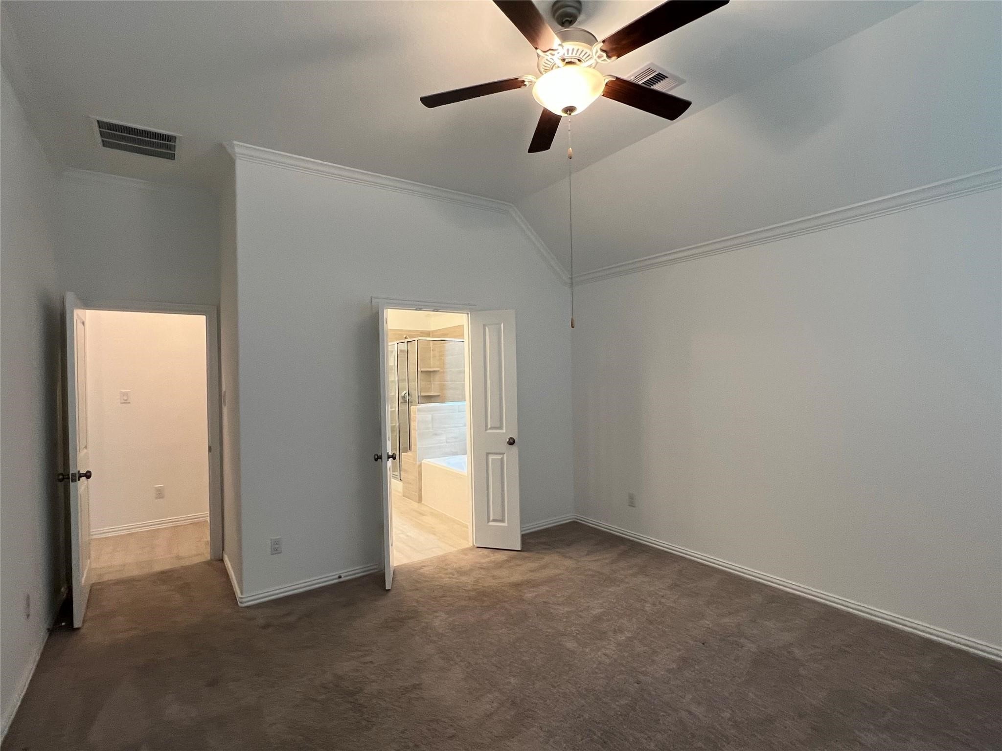 21015 Morning Nectar Lane Cypress, TX 77433 - Photo 22 of 34 an empty room with closet and a chandelier fan
