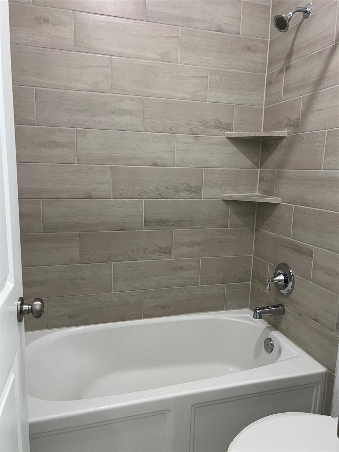 21015 Morning Nectar Lane Cypress, TX 77433 - Photo 26 of 34 a bathroom with a bathtub and a shower