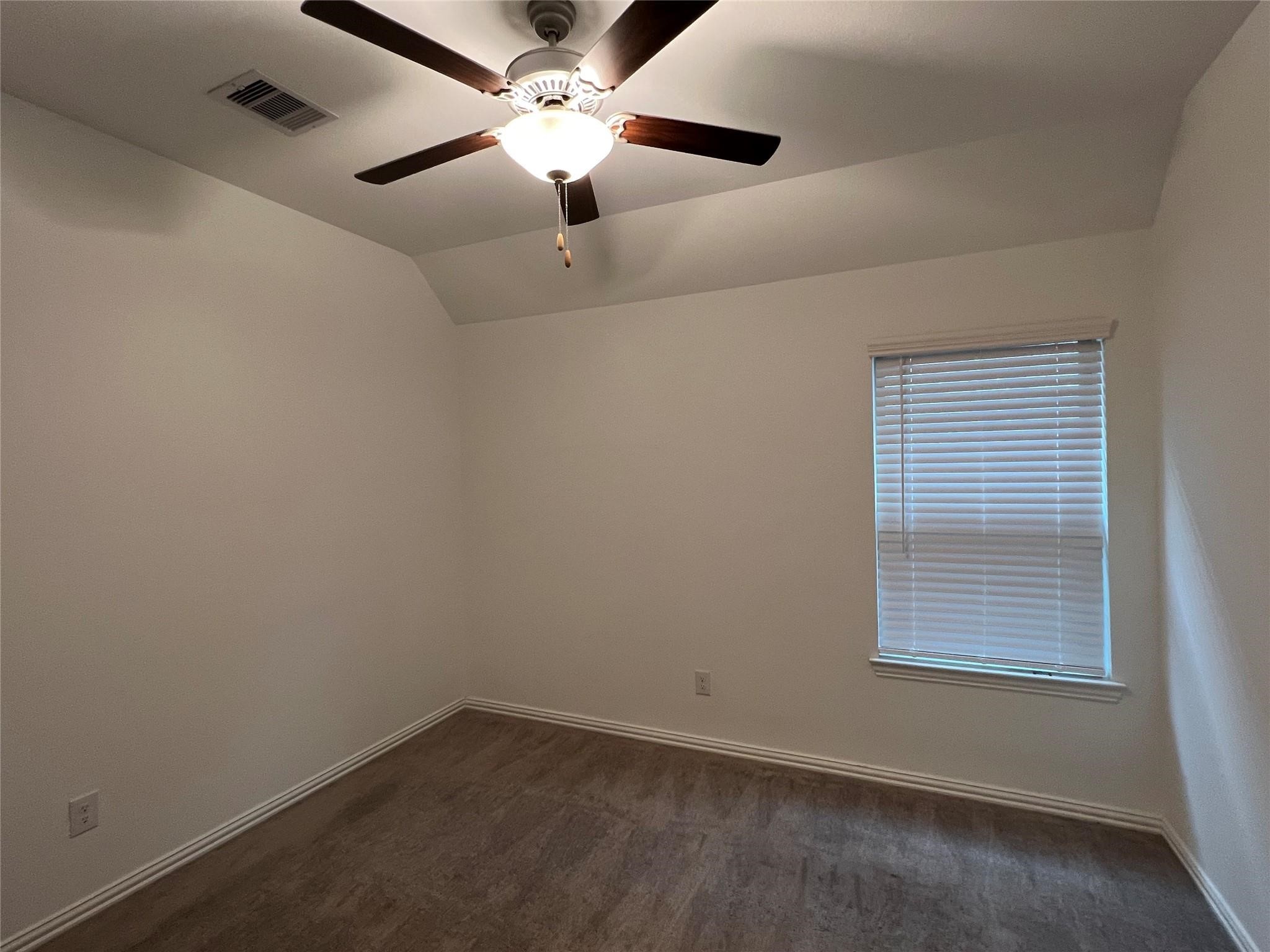 21015 Morning Nectar Lane Cypress, TX 77433 - Photo 27 of 34 an empty room with a window and a fan