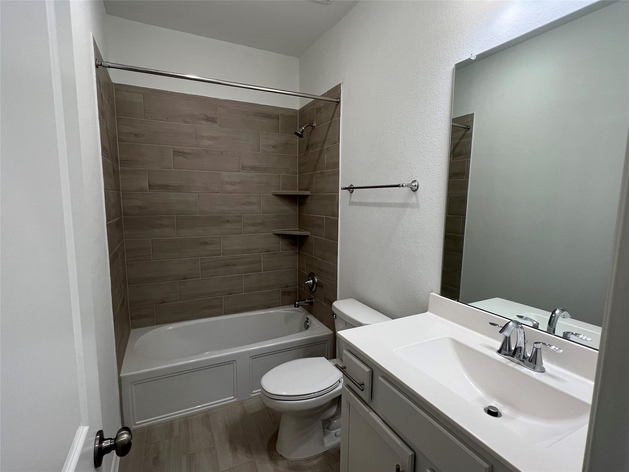 21015 Morning Nectar Lane Cypress, TX 77433 - Photo 28 of 34 a bathroom with a sink toilet and shower