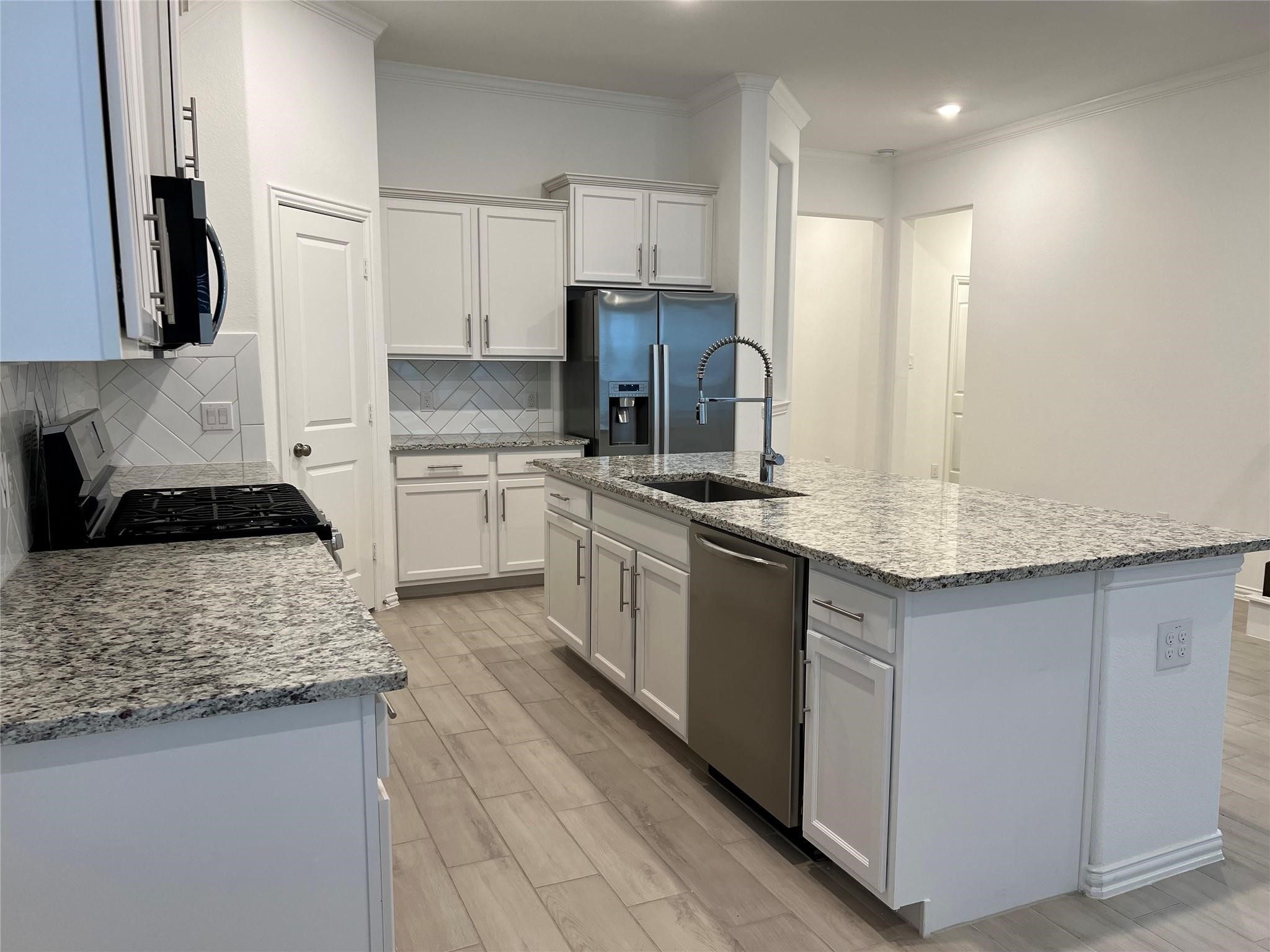 21015 Morning Nectar Lane Cypress, TX 77433 - Photo 5 of 34 a kitchen with stainless steel appliances granite countertop a sink stove and refrigerator