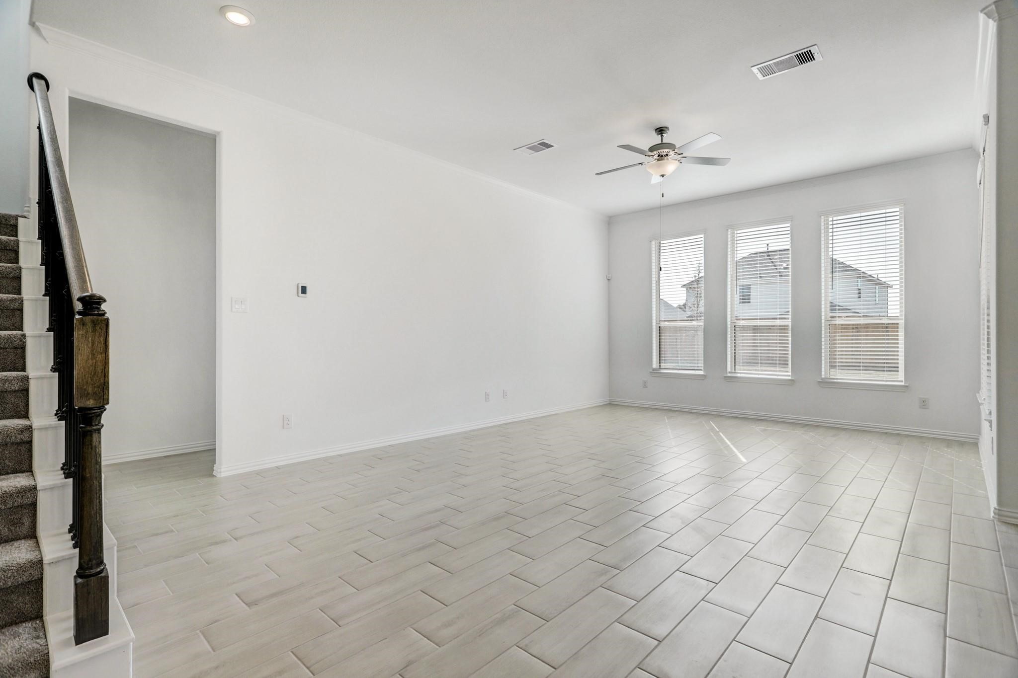 21015 Morning Nectar Lane Cypress, TX 77433 - Photo 10 of 34 an empty room with windows and ceiling fan