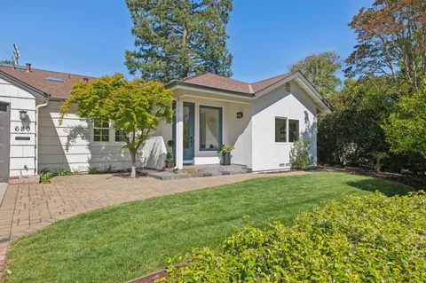a view of a house with a yard and sitting area