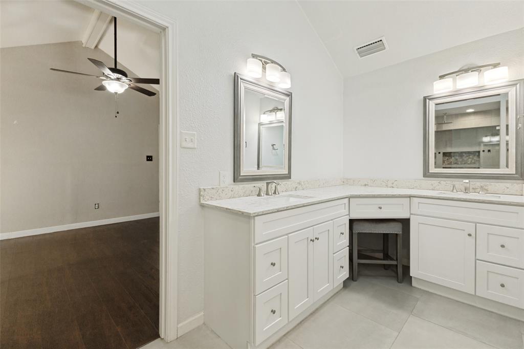 3010 Rambling Drive Dallas, TX 75228 - Photo 15 of 25 Dual vanity with white cabinetry, light-toned countertops, and brushed nickel hardware