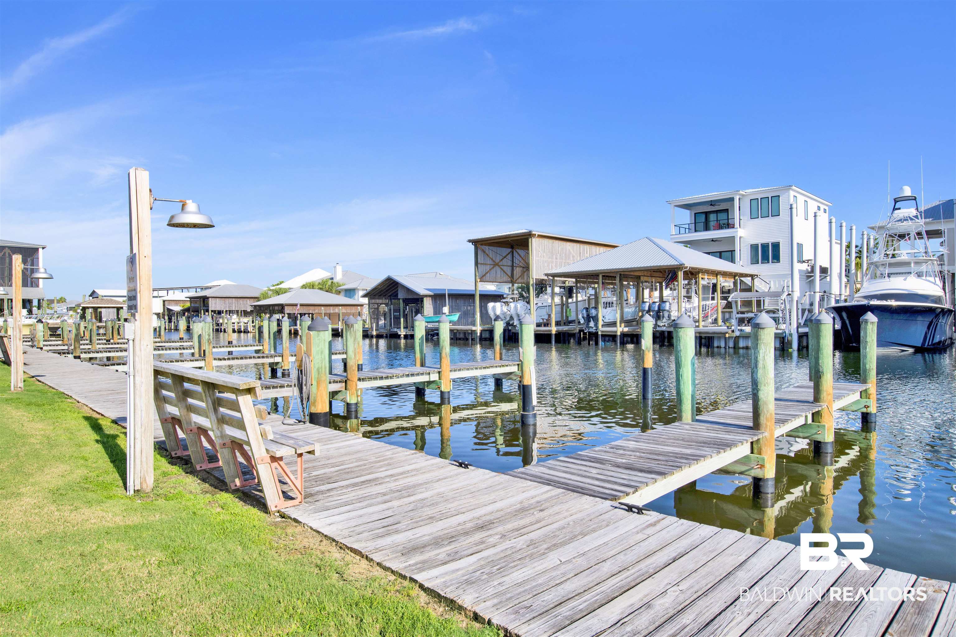 26913 Marina Road, Unit 213 Orange Beach, AL 36561 - Photo 28 of 30 View of dock featuring a water view and a lawn