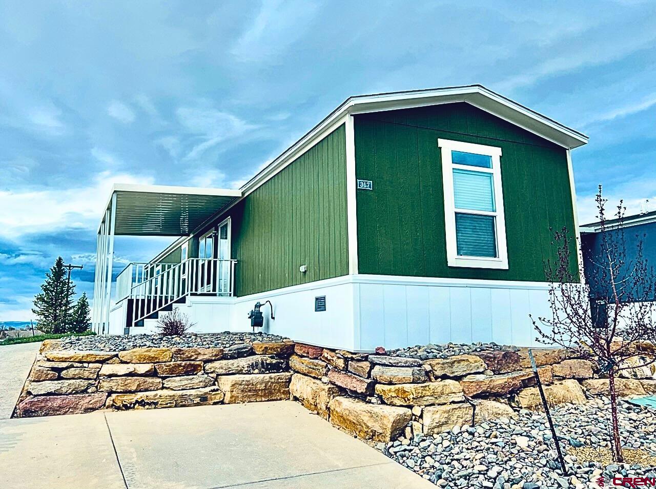 a front view of a house with swimming pool and porch