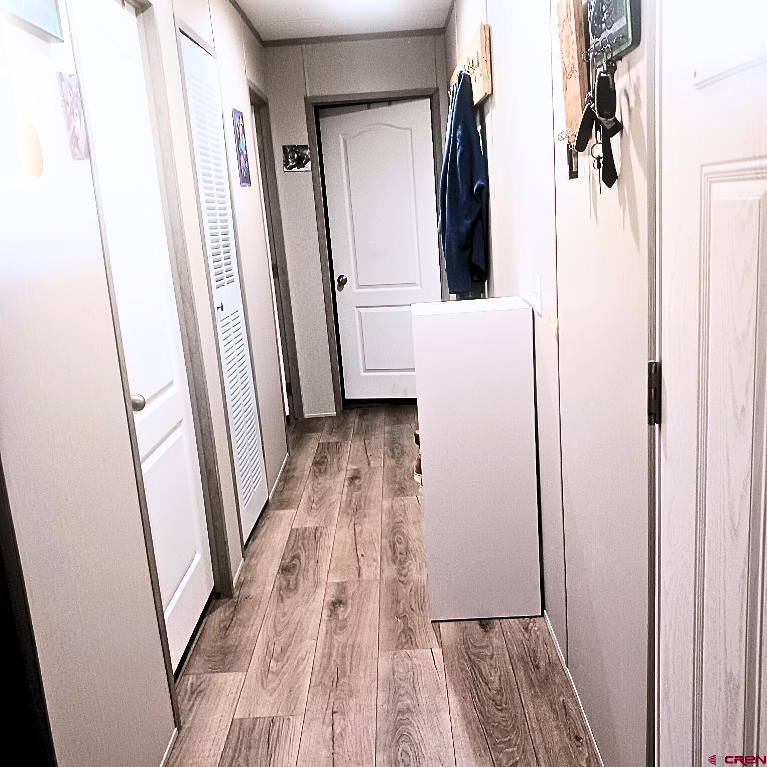 62650 Lasalle Road, Unit 317 Montrose, CO 81403 - Photo 12 of 23 a view of closet with wooden floor and mirror