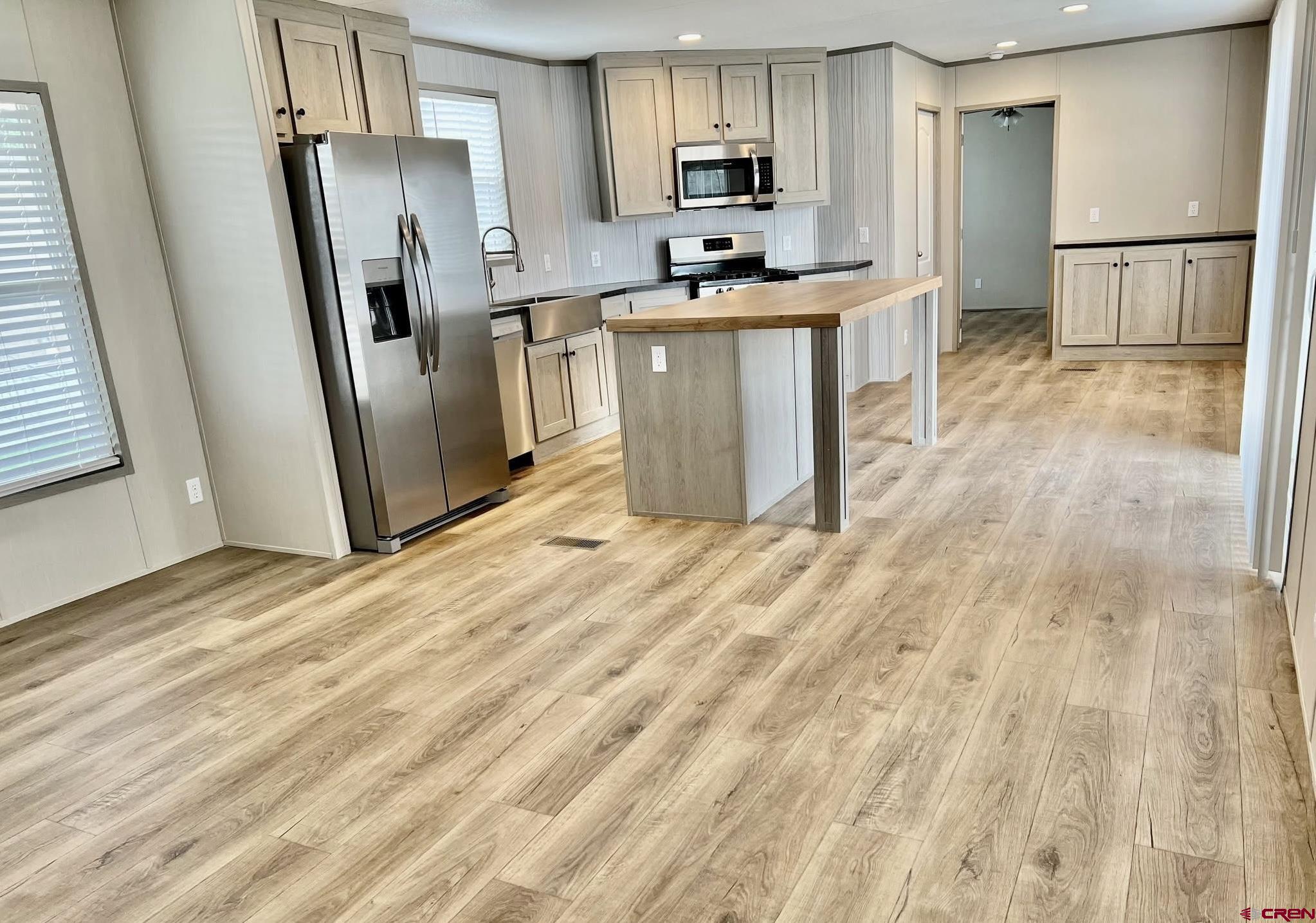 62650 Lasalle Road, Unit 317 Montrose, CO 81403 - Photo 20 of 23 a kitchen with stainless steel appliances a refrigerator and a sink
