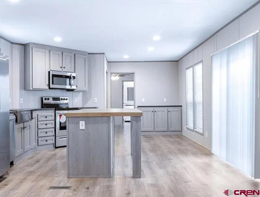 62650 Lasalle Road, Unit 317 Montrose, CO 81403 - Photo 3 of 23 a kitchen with granite countertop white cabinets and stainless steel appliances