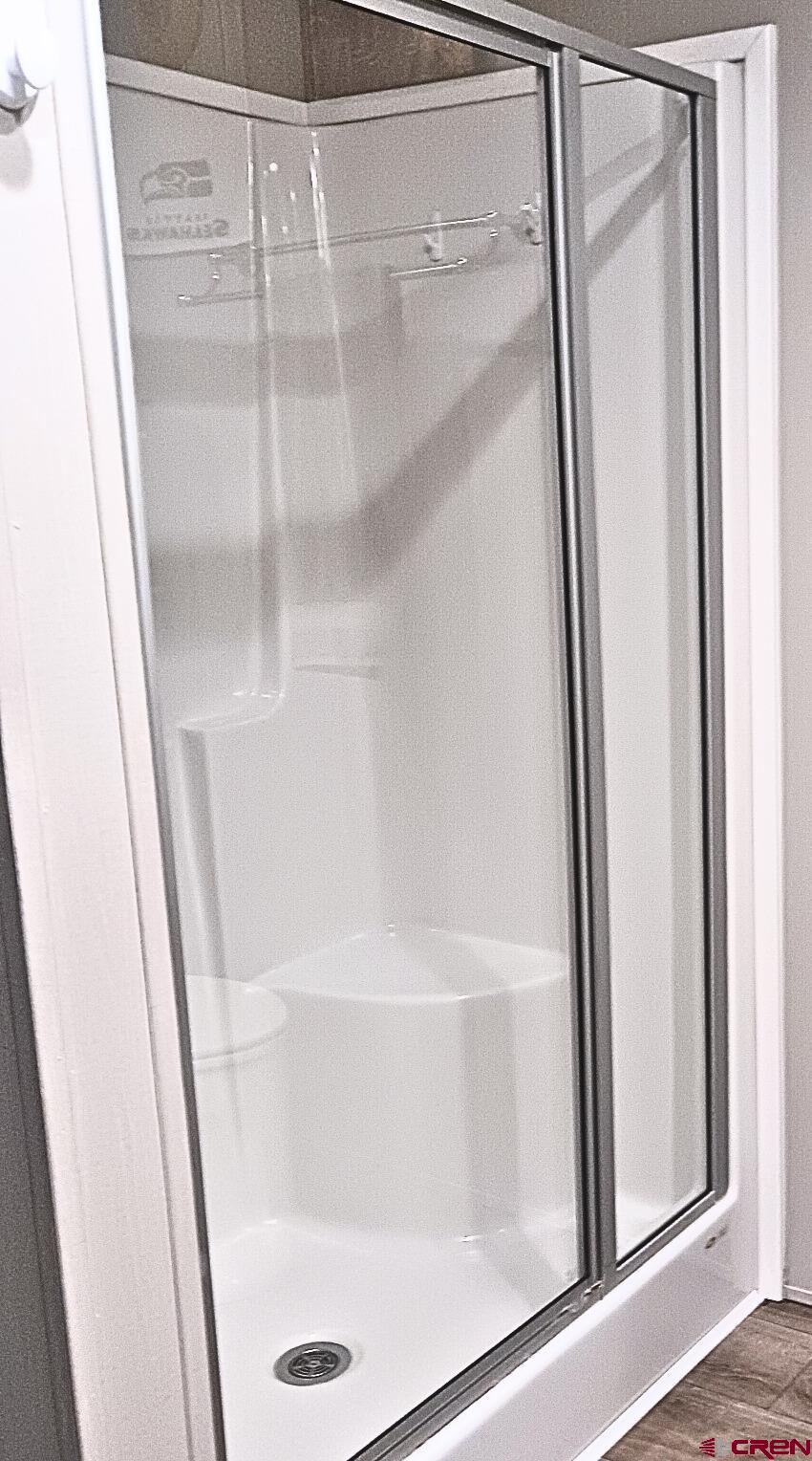 62650 Lasalle Road, Unit 317 Montrose, CO 81403 - Photo 8 of 23 a bathroom with a glass shower door