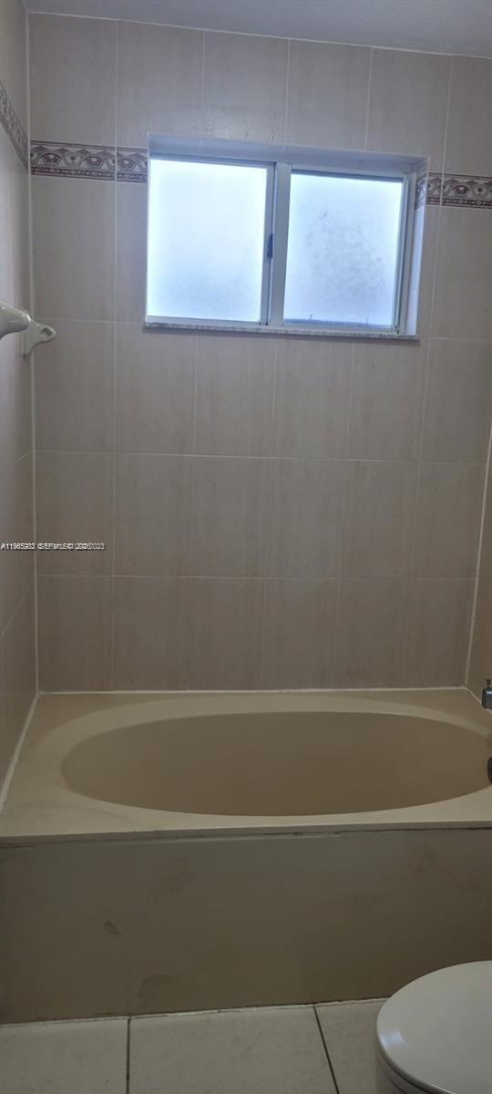 8331 Southwest 124th Avenue, Unit 10114 Miami, FL 33183 - Photo 12 of 19 a bathroom with a toilet and a bath tub