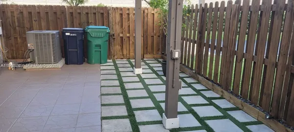 a view of a backyard with table and chairs