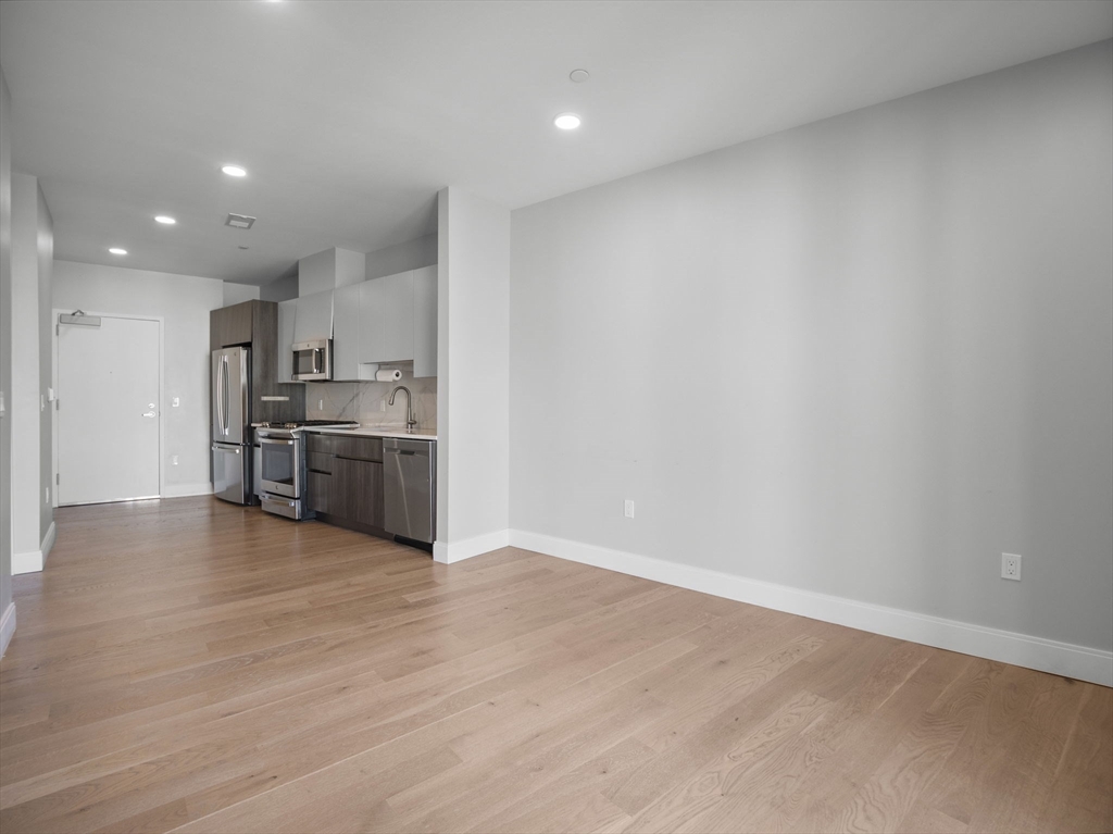 9 Central Street, Unit 207 Somerville, MA 02143 - Photo 11 of 32 a view of kitchen with wooden floor