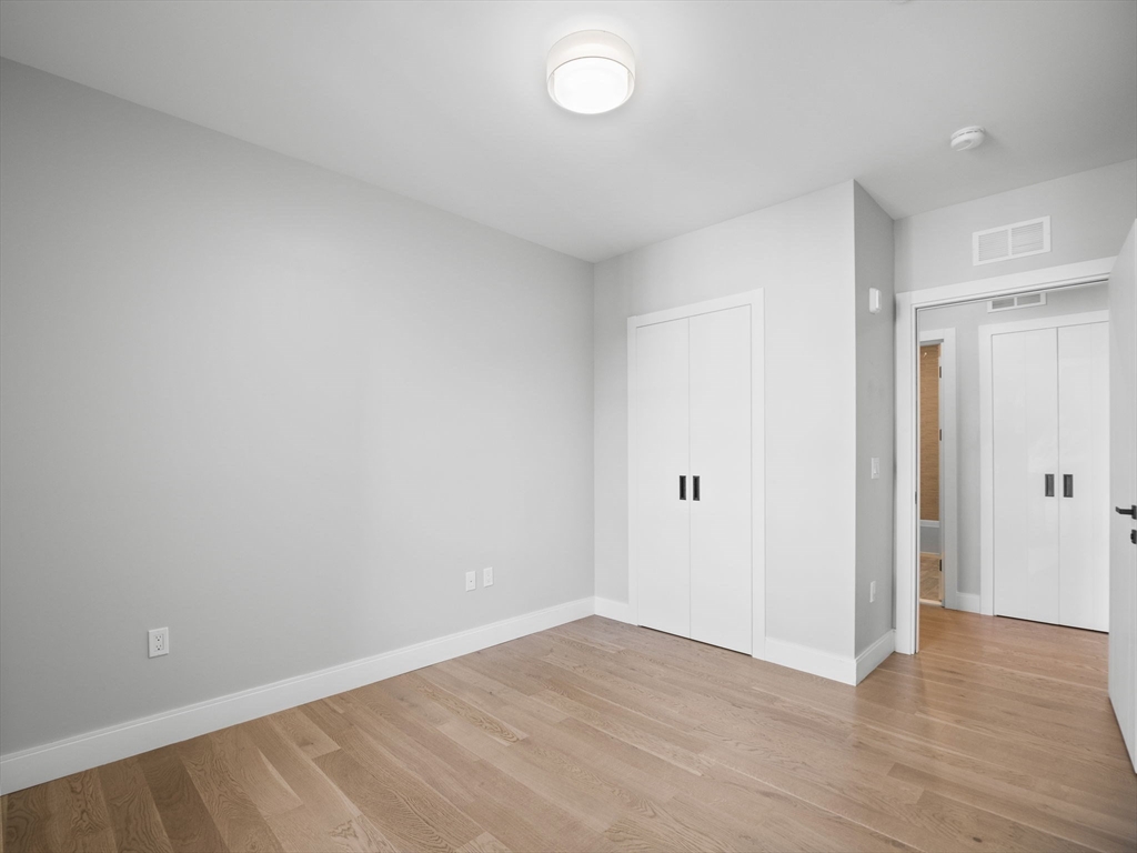 9 Central Street, Unit 207 Somerville, MA 02143 - Photo 13 of 32 a view of an empty room and wooden floor