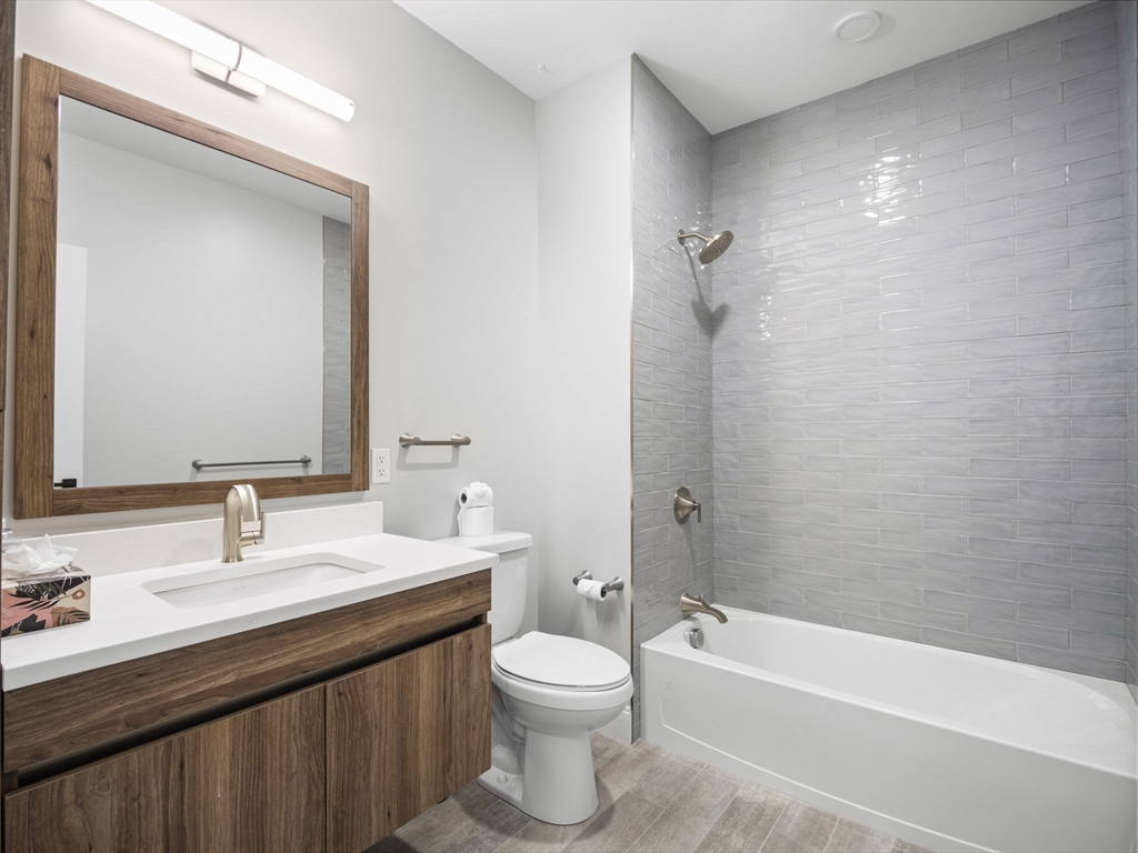 9 Central Street, Unit 207 Somerville, MA 02143 - Photo 16 of 32 a bathroom with a sink a toilet and shower