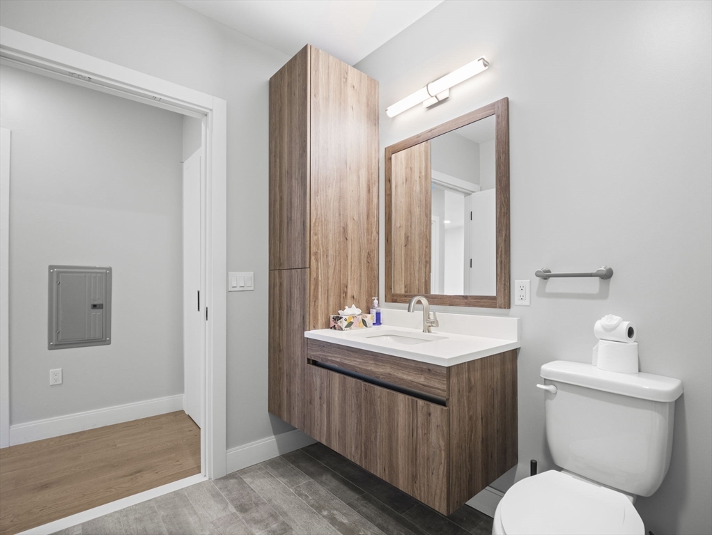 9 Central Street, Unit 207 Somerville, MA 02143 - Photo 17 of 32 a bathroom with a toilet sink and mirror