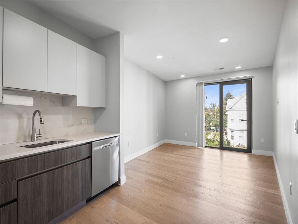 9 Central Street, Unit 207 Somerville, MA 02143 - Photo 2 of 32 a view of a kitchen with a sink and a window