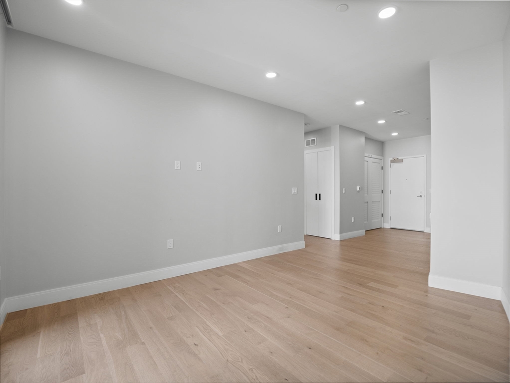 9 Central Street, Unit 207 Somerville, MA 02143 - Photo 8 of 32 a view of an empty room with wooden floor