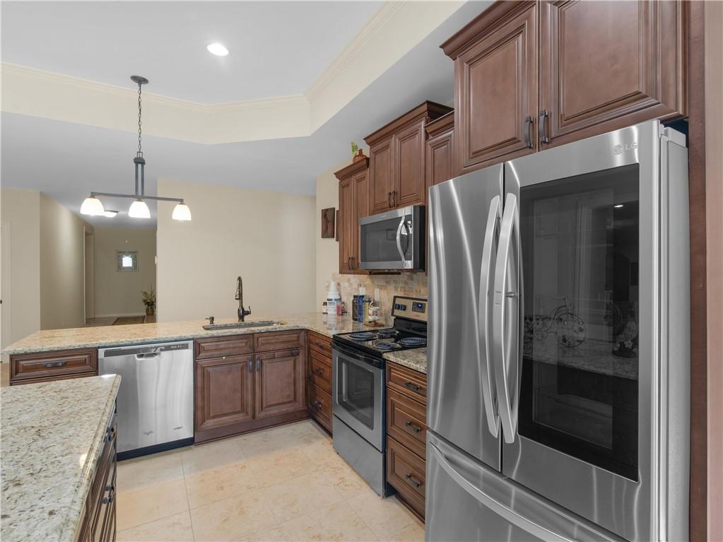 1695 Whitley Road Dacula, GA 30019 - Photo 117 of 153 a kitchen with stainless steel appliances granite countertop a refrigerator a sink a stove and a sink with wooden floor