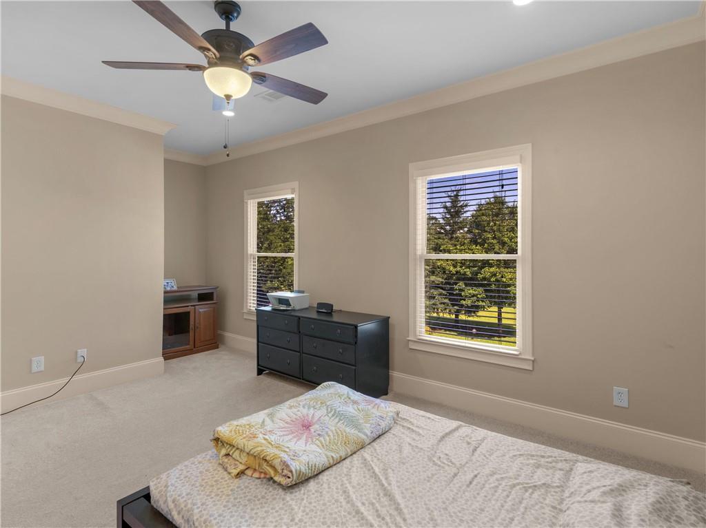 1695 Whitley Road Dacula, GA 30019 - Photo 130 of 153 a bedroom with a bed and a chandelier