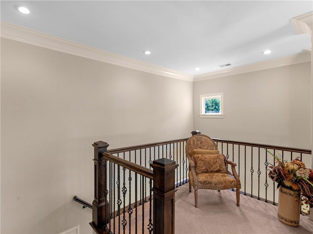 1695 Whitley Road Dacula, GA 30019 - Photo 147 of 153 a view of a hallway with wooden floor and a potted plant