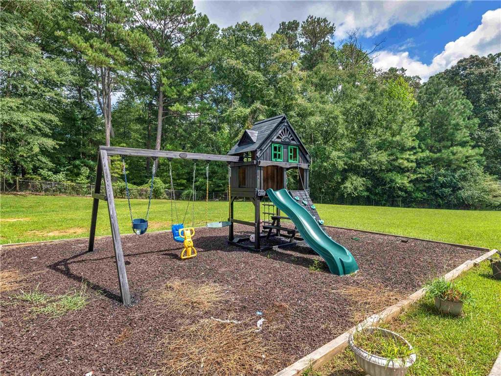 1695 Whitley Road Dacula, GA 30019 - Photo 16 of 153 a view of a park with slide