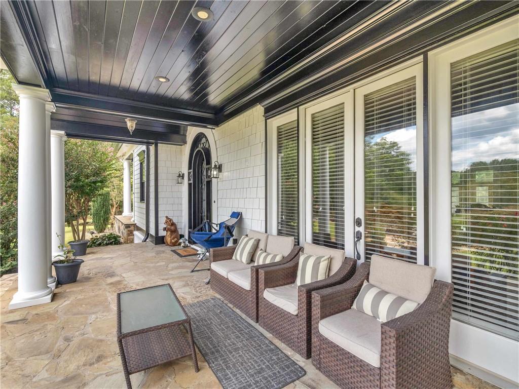 1695 Whitley Road Dacula, GA 30019 - Photo 21 of 153 a living room with furniture and floor to ceiling windows