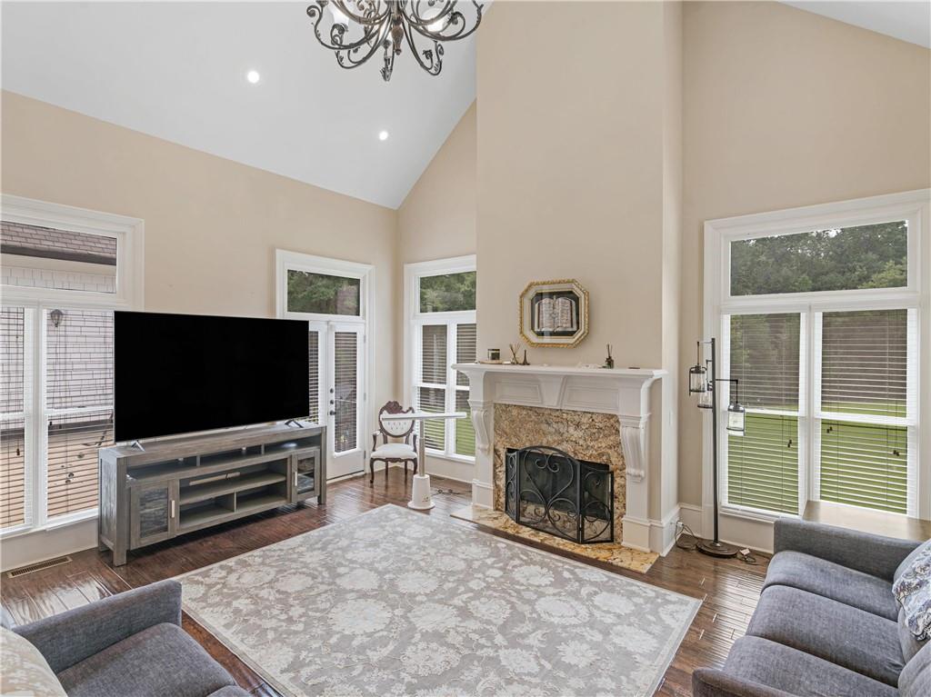 1695 Whitley Road Dacula, GA 30019 - Photo 32 of 153 a living room with furniture a flat screen tv and a fireplace