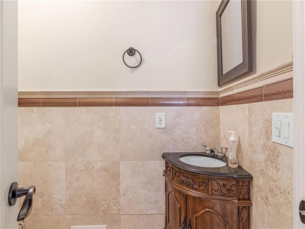 1695 Whitley Road Dacula, GA 30019 - Photo 47 of 153 a bathroom with a sink a mirror and a toilet