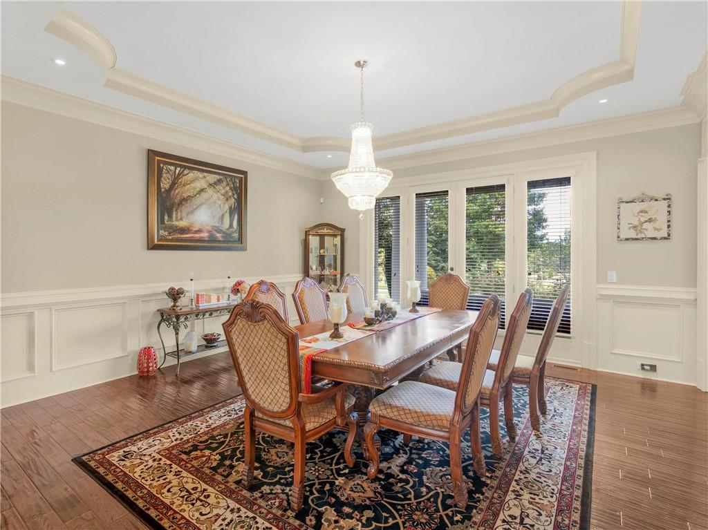 1695 Whitley Road Dacula, GA 30019 - Photo 65 of 153 a dining room with furniture a chandelier and wooden floor