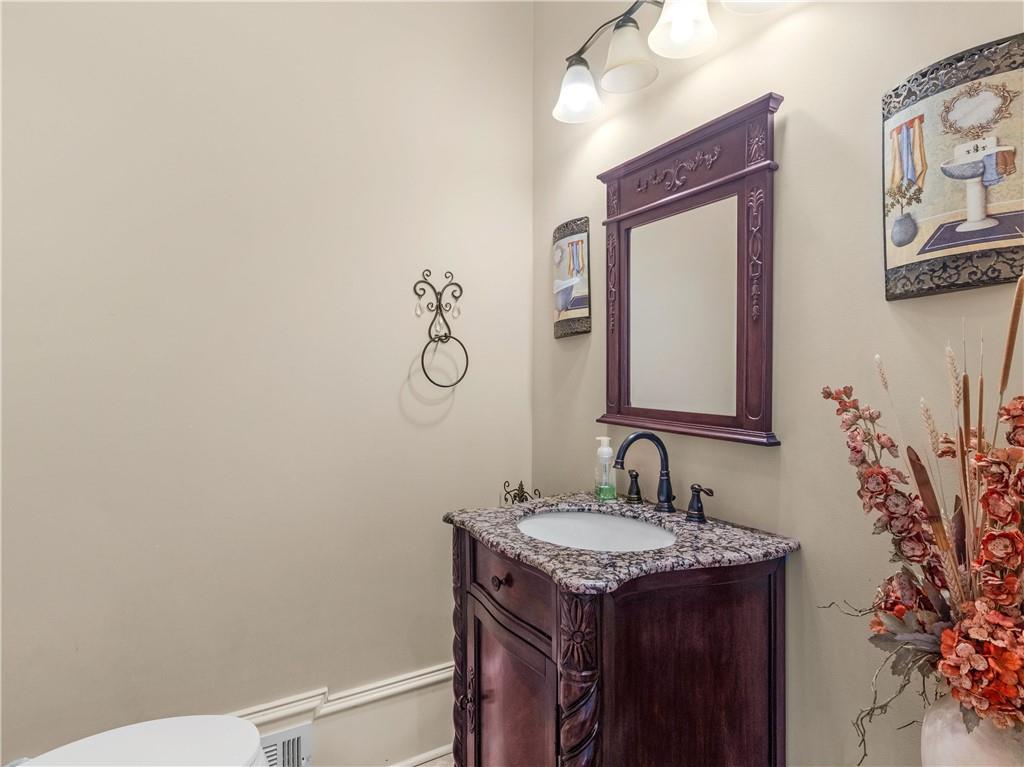 1695 Whitley Road Dacula, GA 30019 - Photo 72 of 153 a bathroom with a granite countertop sink and a mirror