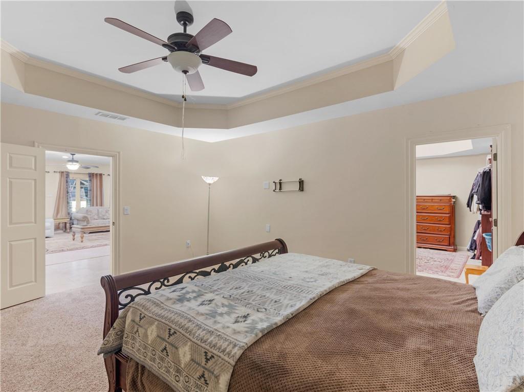 1695 Whitley Road Dacula, GA 30019 - Photo 89 of 153 a bedroom with a bed and a chandelier