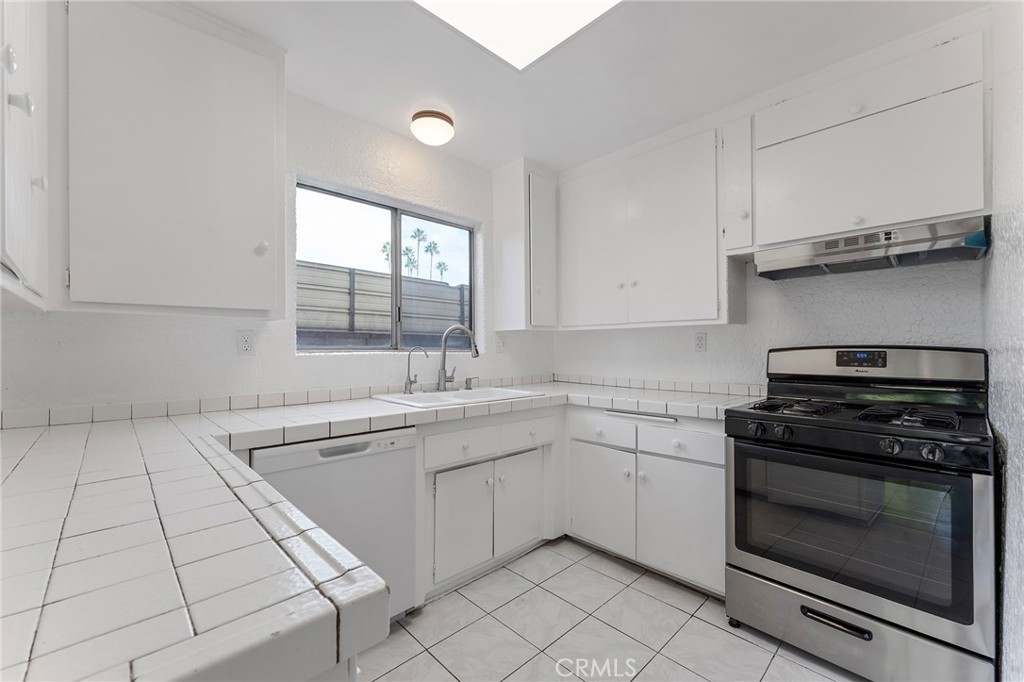 807 East Calbas Street Carson, CA 90745 - Photo 12 of 31 a kitchen with cabinets appliances and a window