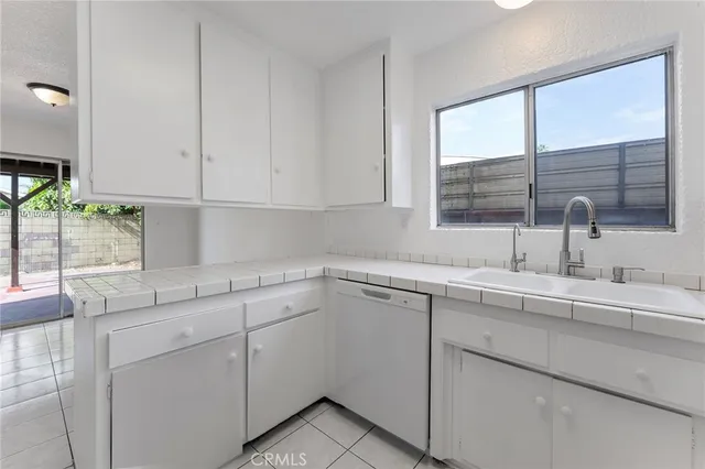a kitchen with a sink cabinets and window