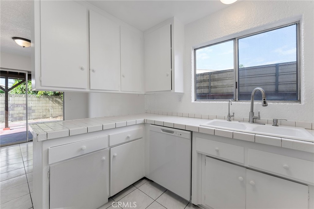 807 East Calbas Street Carson, CA 90745 - Photo 13 of 31 a kitchen with a sink cabinets and window