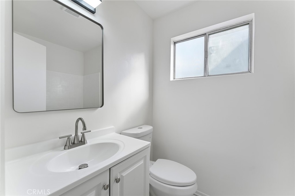 807 East Calbas Street Carson, CA 90745 - Photo 16 of 31 a bathroom with a toilet sink and mirror