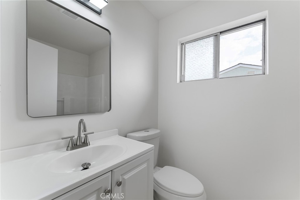 807 East Calbas Street Carson, CA 90745 - Photo 24 of 31 a bathroom with a sink vanity mirror and toilet