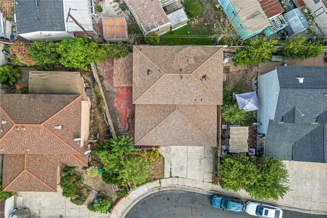an aerial view of a house with a yard and garden
