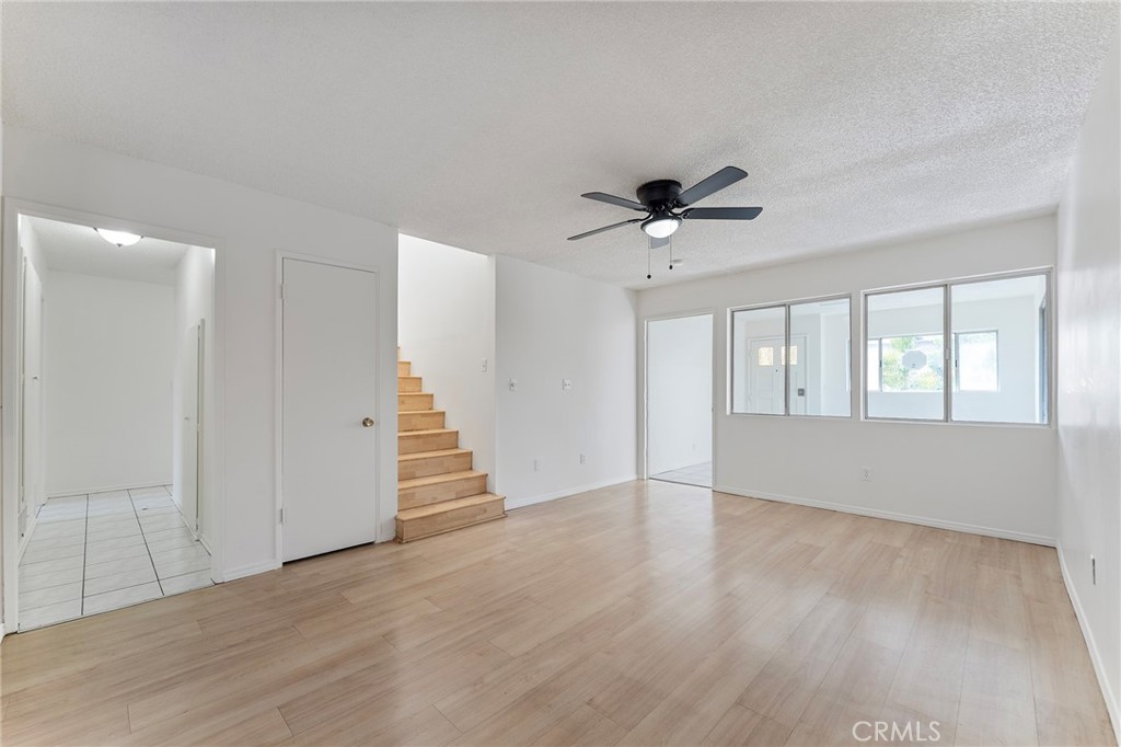 807 East Calbas Street Carson, CA 90745 - Photo 9 of 31 a view of an empty room with wooden floor and a ceiling fan
